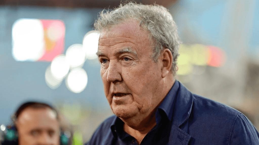 Jeremy Clarkson standing in a field at Diddly Squat Farm looking emotional, wearing a casual jacket