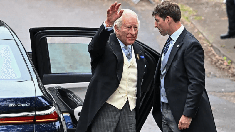 King Charles and Queen Camilla waving to well-wishers outside All Saints Church in Kemble, Gloucestershire, before departing for the Epsom Derby