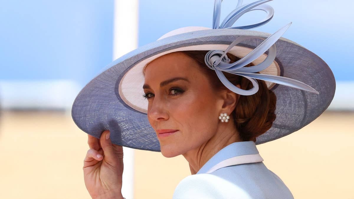 The Princess of Wales in a baby-blue Catherine Walker coat dress and Philip Treacy hat, seated in an Ascot Landau carriage with Prince George, Princess Charlotte and Prince Louis during the Trooping the Colour 2026 procession along the Mall