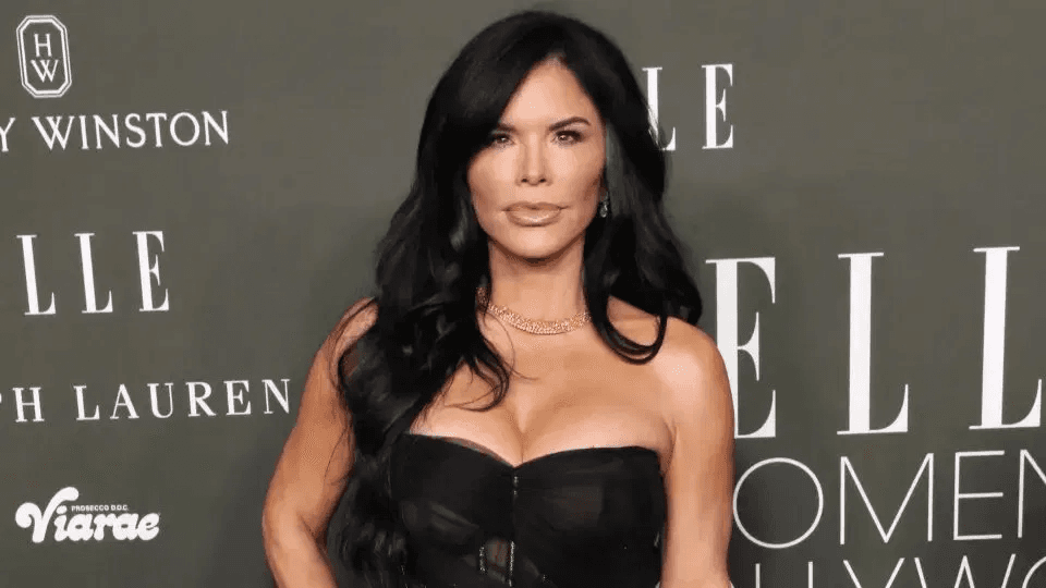 Lauren Sanchez Bezos in a sky-blue vintage John Galliano Dior crochet dress in Paris, accessorised with a silver Chanel clutch and oversized diamond earrings