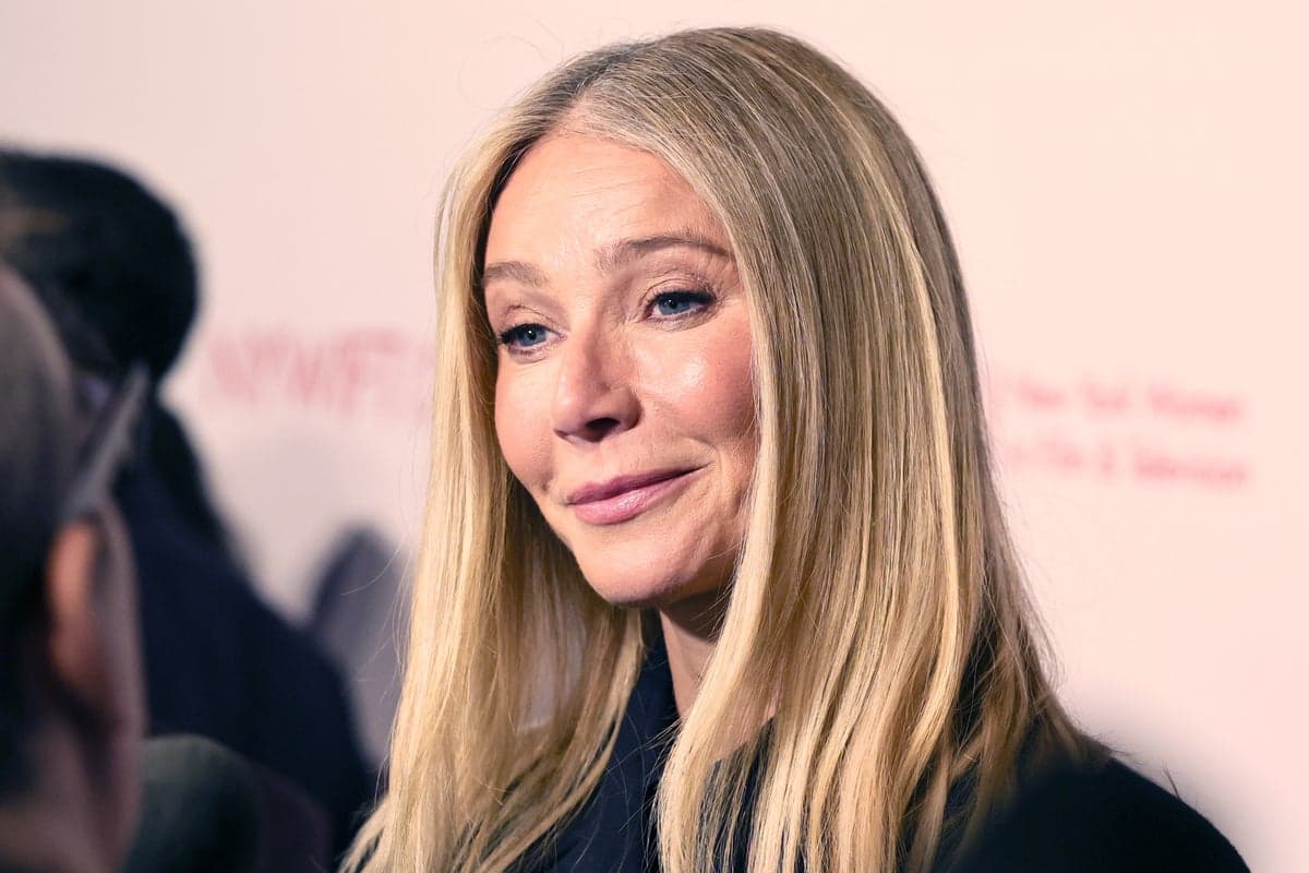 Gwyneth Paltrow attends a public event, smiling at cameras