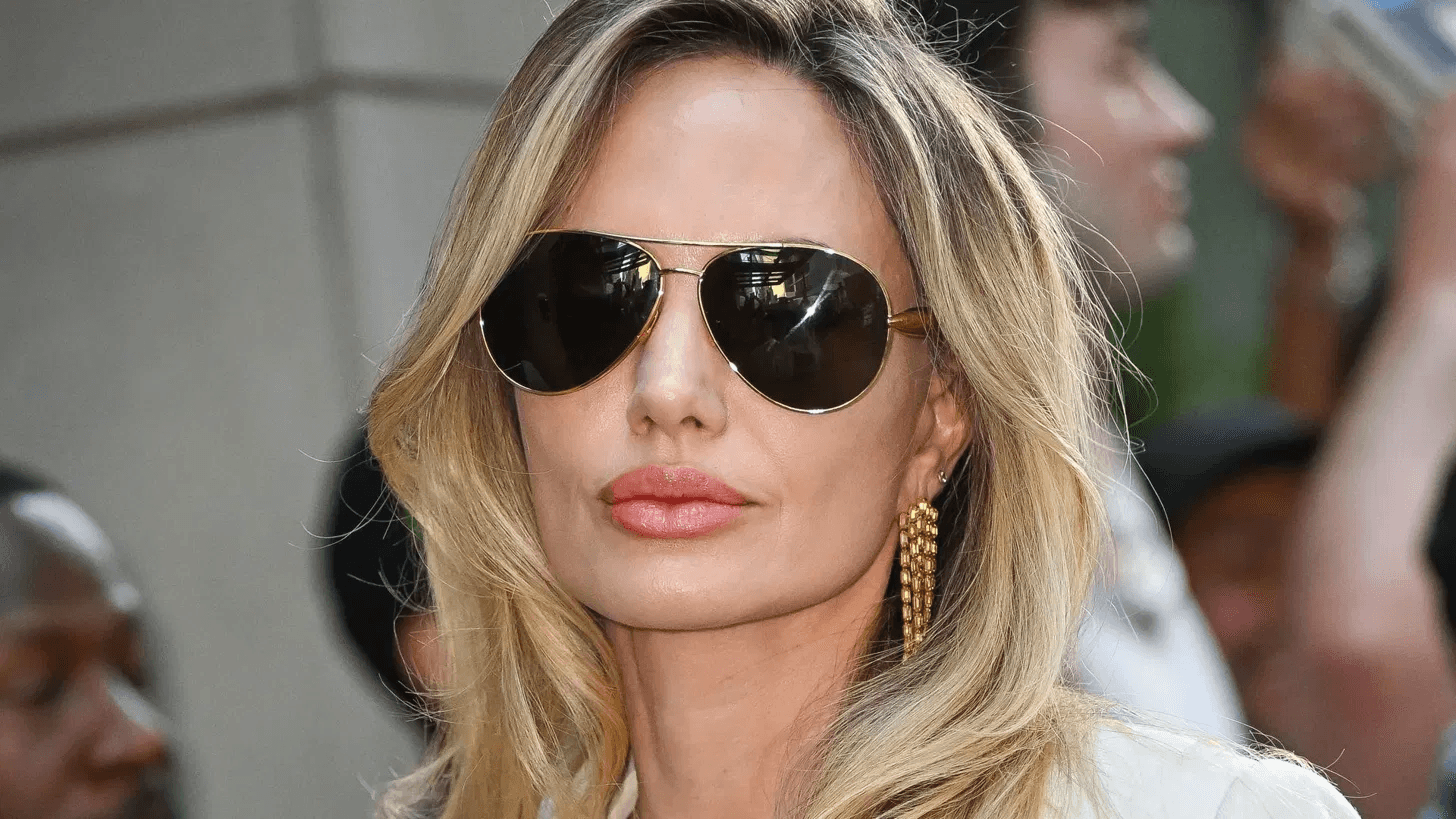 Angelina Jolie attends a public event, photographed from the front in a formal setting