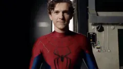 A figure in a red and blue superhero suit perched on a rain-slicked rooftop at night, city skyscrapers lit up behind them