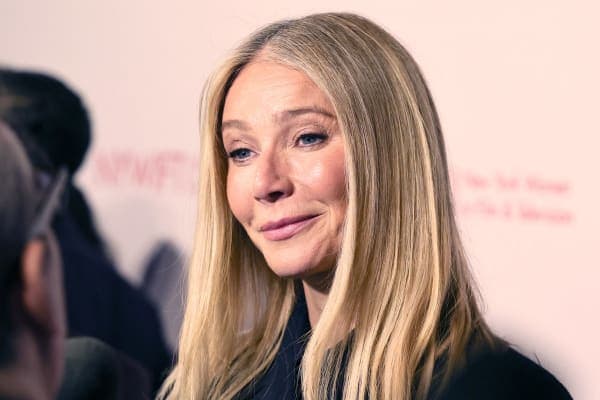 Gwyneth Paltrow attends a public event, smiling at cameras