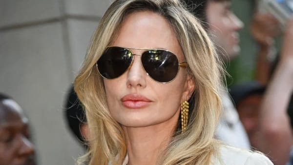 Angelina Jolie attends a public event, photographed from the front in a formal setting