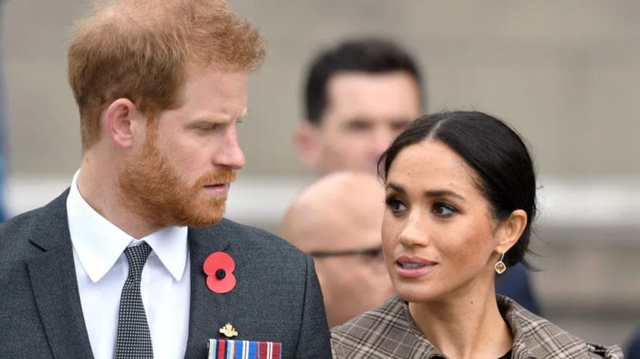 Prince Harry and Meghan Markle standing on the Buckingham Palace balcony during the 2019 Trooping the Colour ceremony, surrounded by members of the Royal Family