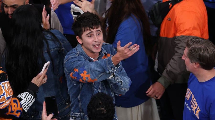 Timothée Chalamet celebrating wildly with fans inside Madison Square Garden after the New York Knicks' Game 4 NBA Finals win