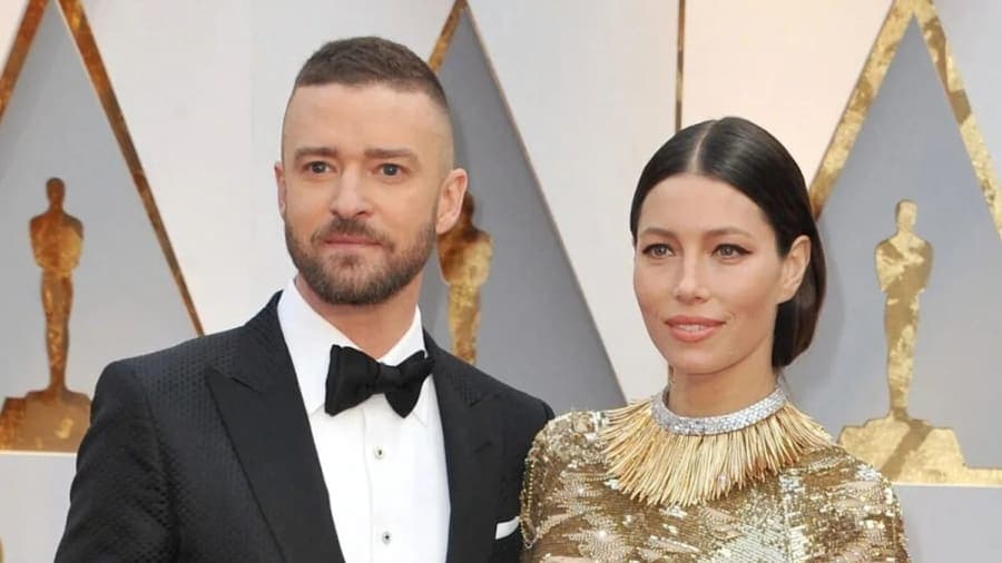 Justin Timberlake and Jessica Biel walking hand-in-hand on a New York City street, both wearing matching all-black outfits and sunglasses