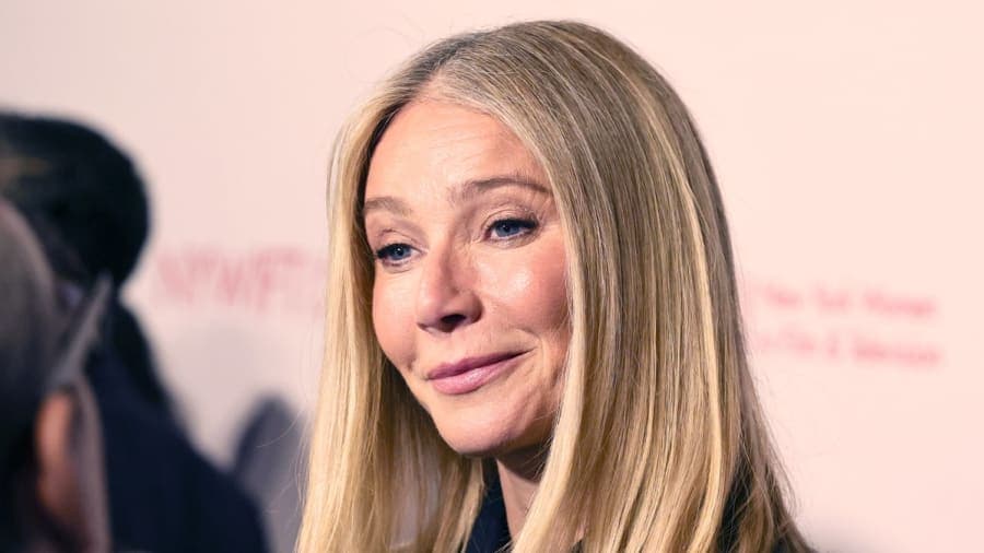 Gwyneth Paltrow attends a public event, smiling at cameras