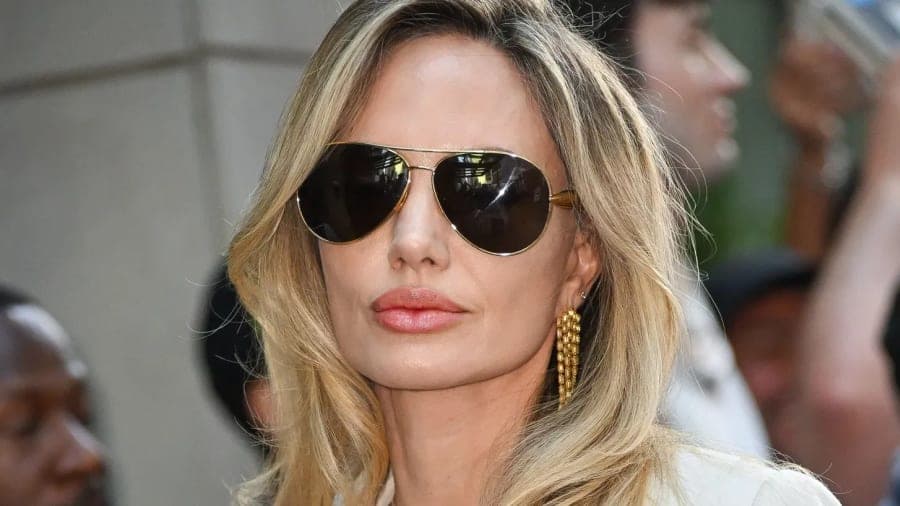 Angelina Jolie attends a public event, photographed from the front in a formal setting