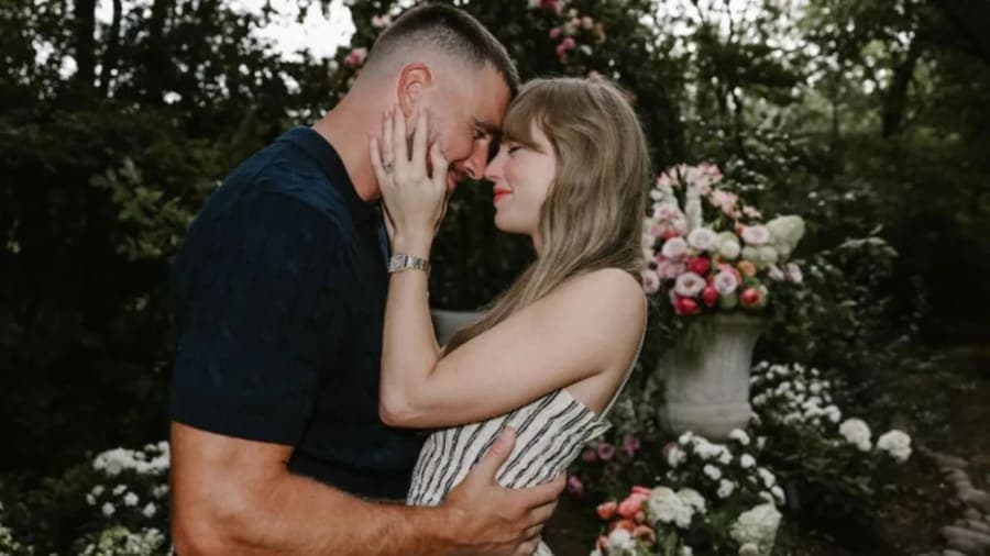 Travis Kelce and Taylor Swift at a public event together, smiling