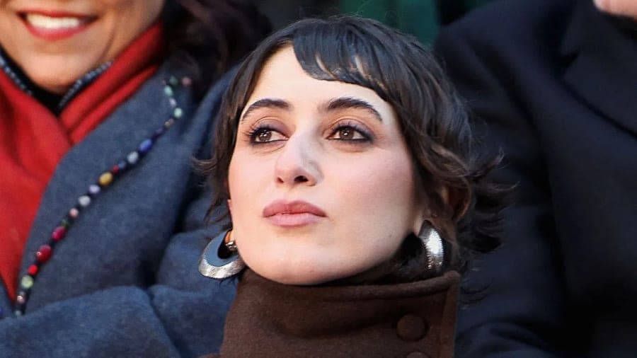 Rama Duwaji wearing a patchwork Knicks-themed top and black vintage skirt at the New York City Knicks Championship Ticker-Tape Parade alongside Mayor Zohran Mamdani