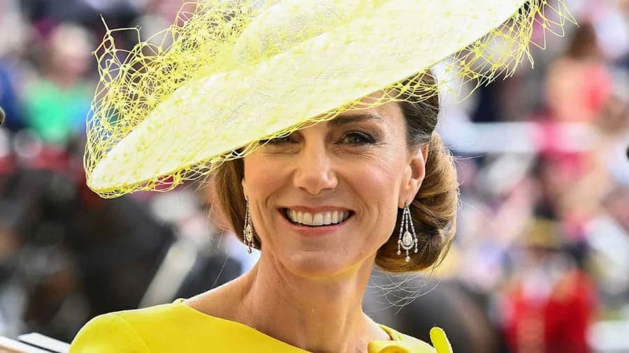 Princess Kate in a yellow dress and matching hat waving from a horse-drawn carriage during the Royal Procession at Royal Ascot 2025