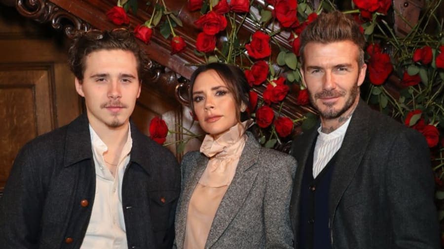 David Beckham smiling at a public event, with Brooklyn Beckham pictured separately at a different occasion