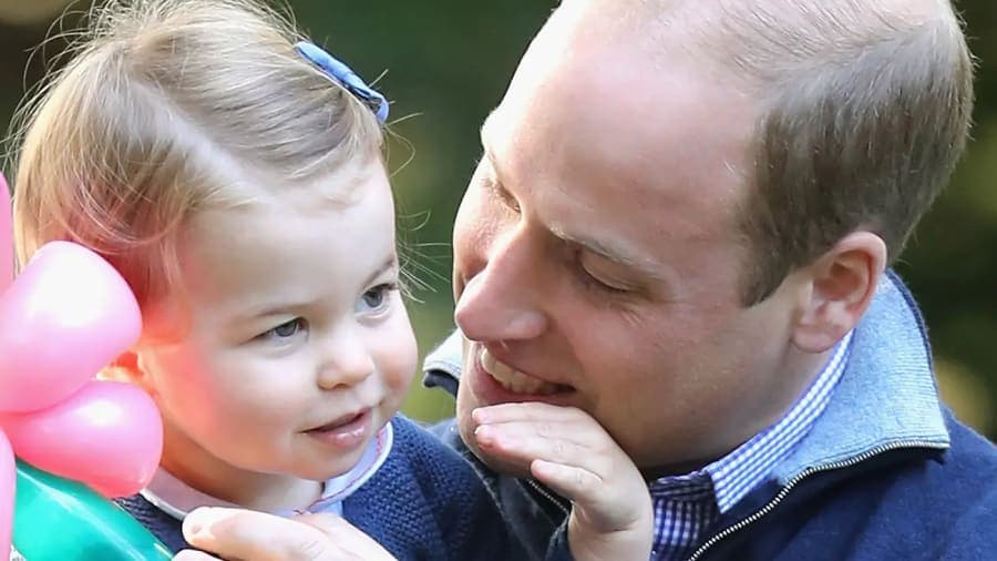 Prince William in Welsh Guards dress uniform standing alongside Princess Charlotte in the garden of Kensington Palace following Trooping the Colour