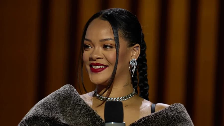 A woman in bold jewellery and stylish clothing photographed at a high-profile fashion event in Paris